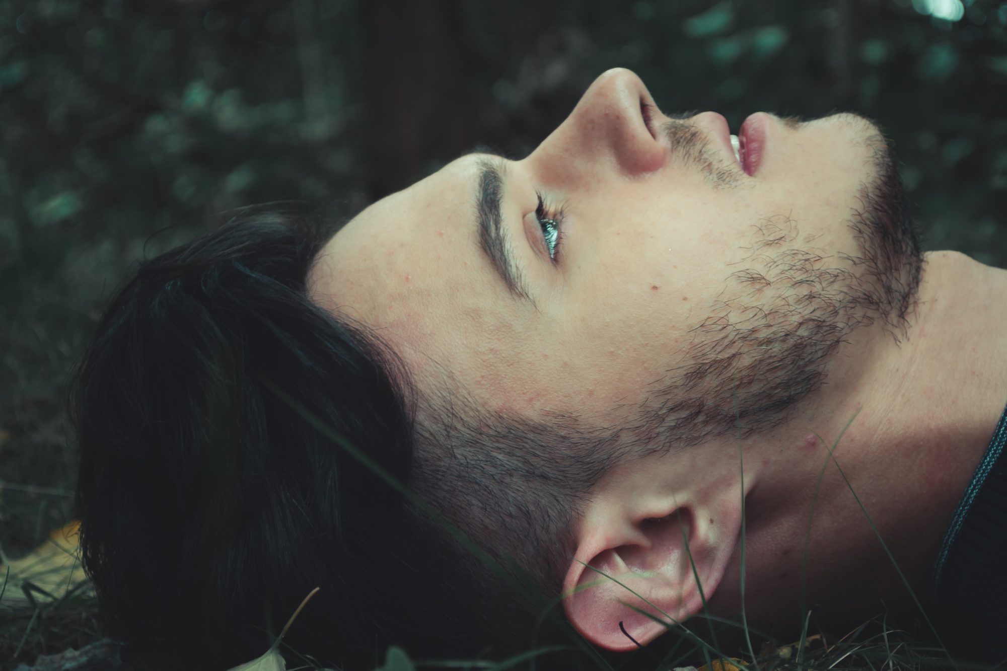 man lying on th4e grass looking up